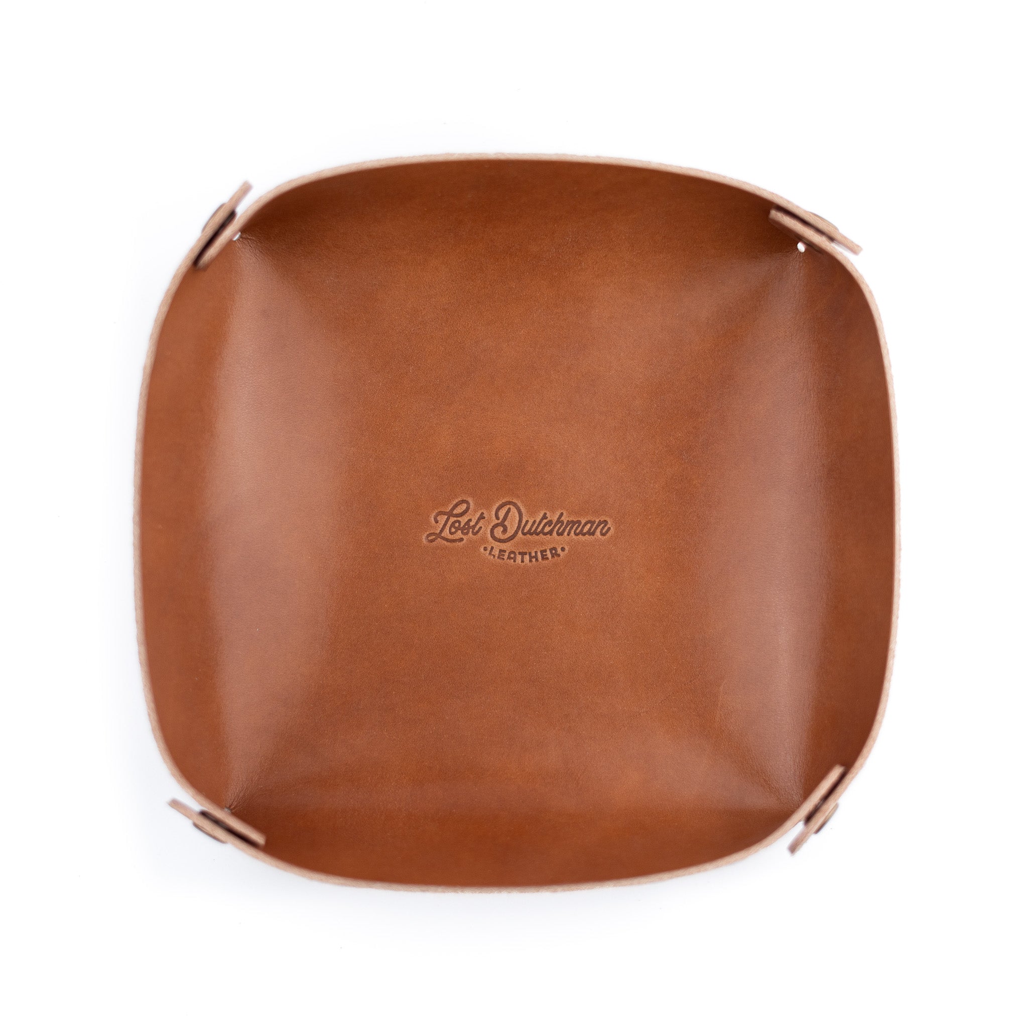Brown leather valet tray with Lost Dutchman Leather logo stamped on it